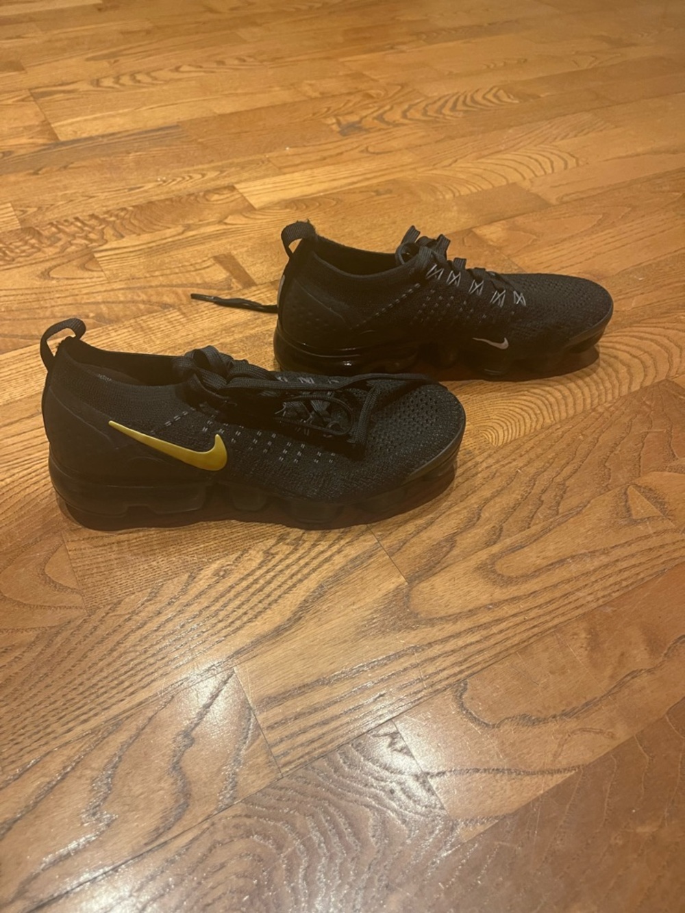 Nike Black Knit Sneakers with Gold Swoosh Accent